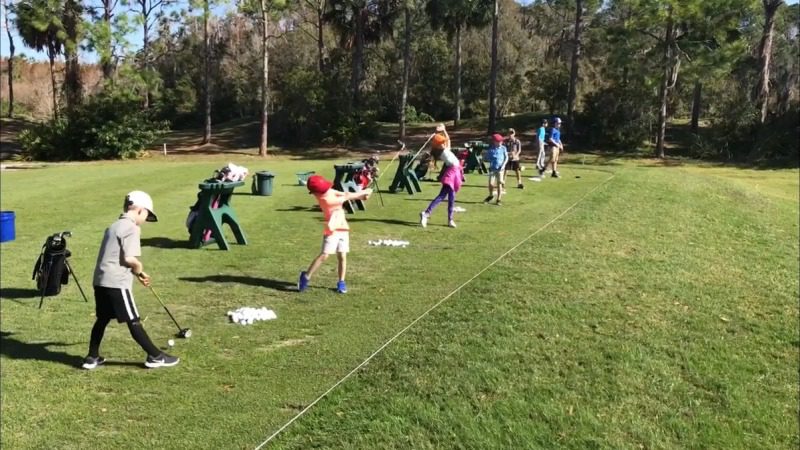 Junior Golf Camp 1/2 Day – Daily Fee A group of kids playing baseball on the grass.