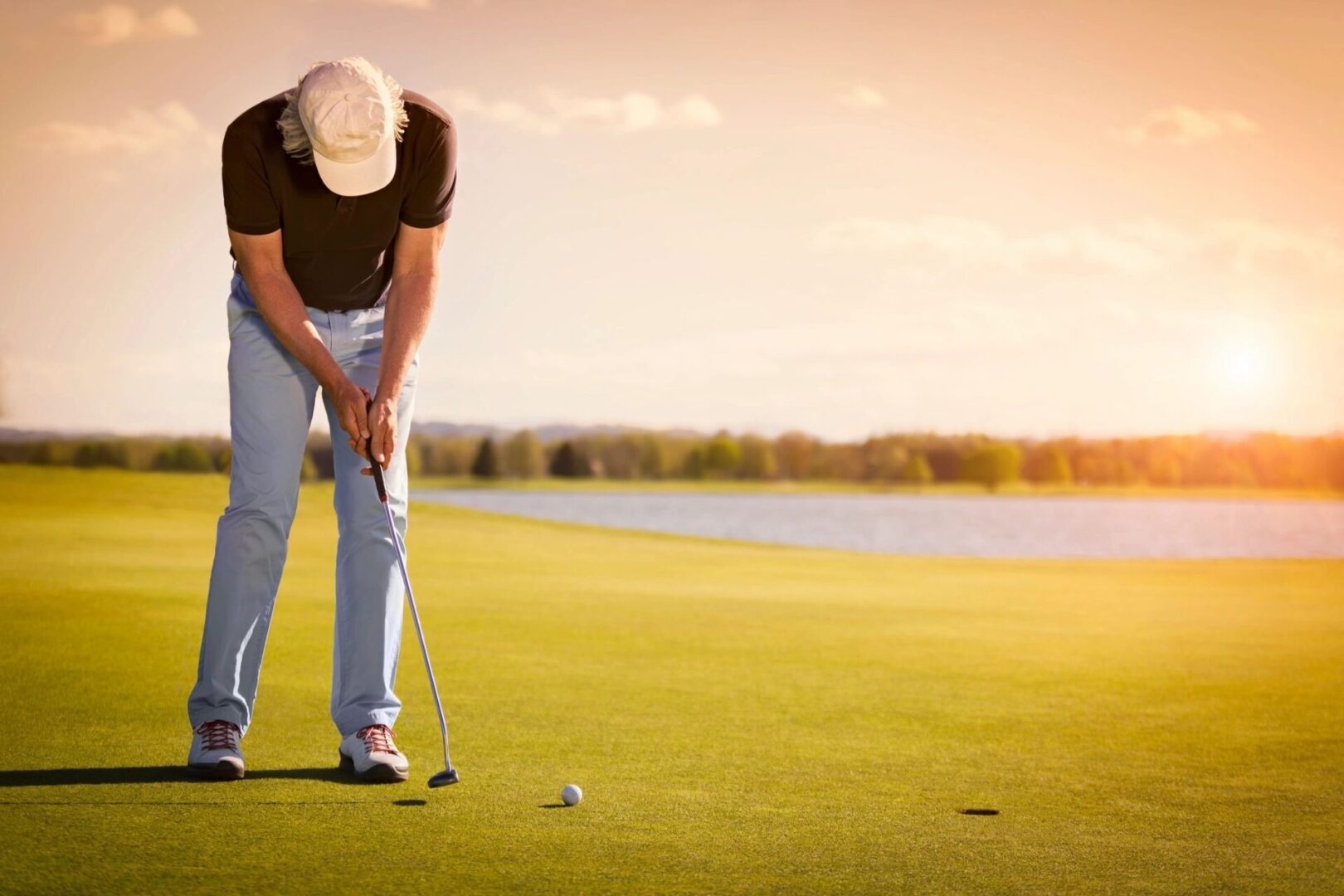 A man is playing golf on the green
