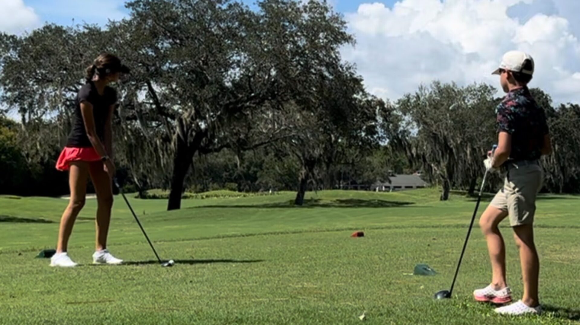 Lauren and Connor 202409 A golf course with trees and grass in the background.