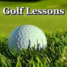 A golf ball sitting in the grass with text that reads " golf lessons ".