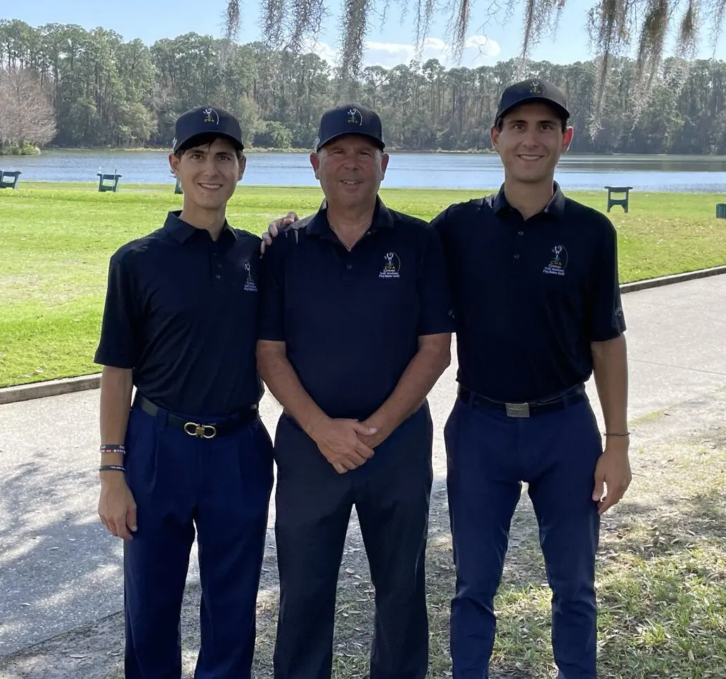 Three men in navy blue shirts and hats standing next to each other.